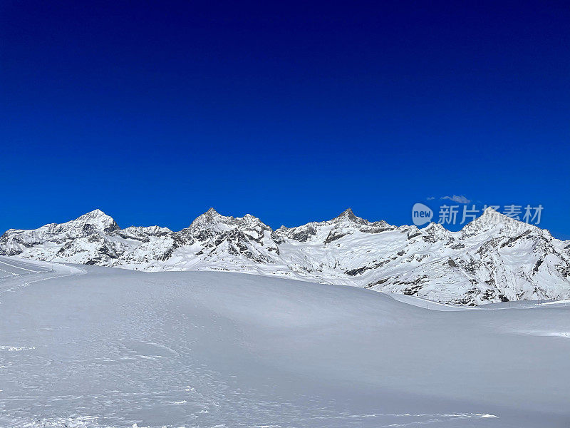 Beautiful mountain panorama in the Swiss Alps with snow covered mountains.